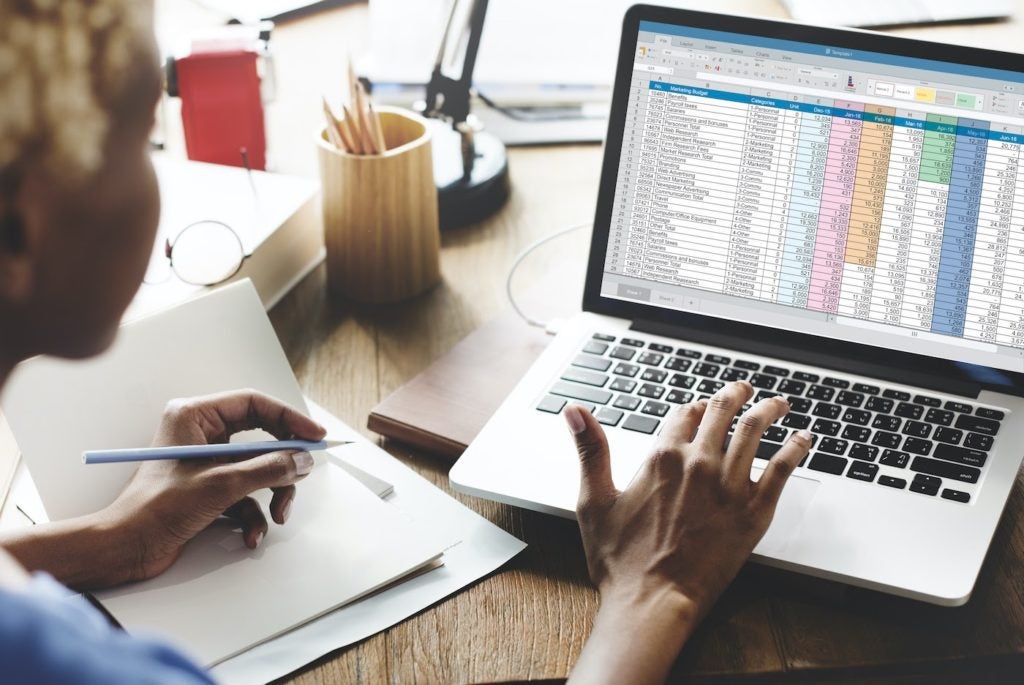 Business woman using spreadsheet for IT cost transparency