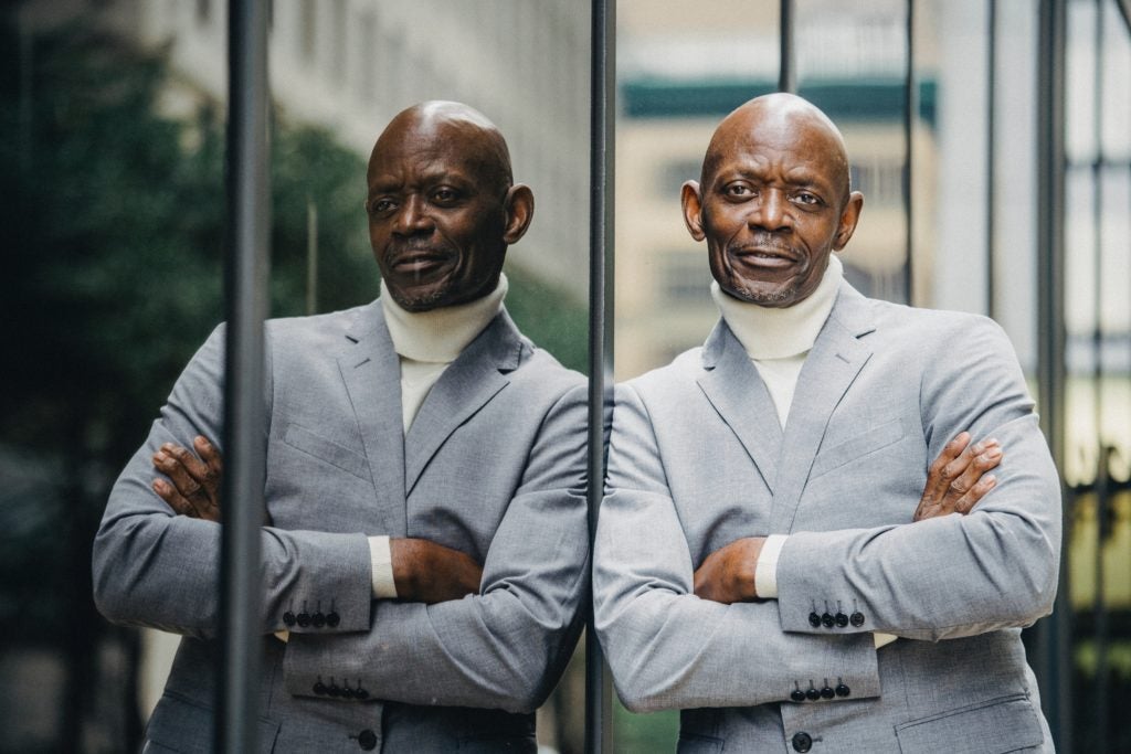 Executive businessman leans against window