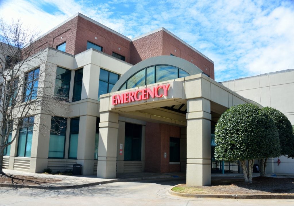 Healthcare ERP represented by image of hospital network building.